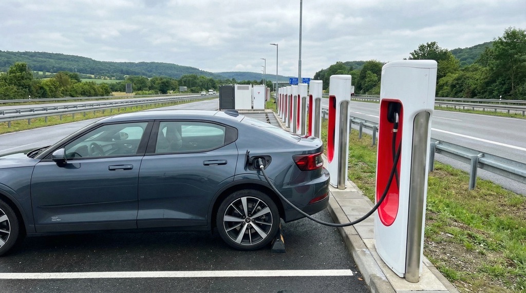 Polestar electric car charging at a Tesla Supercharger station in Europe